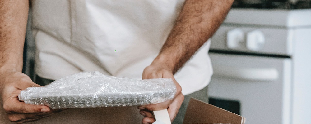 Persona empaquetando con papel de burbuja